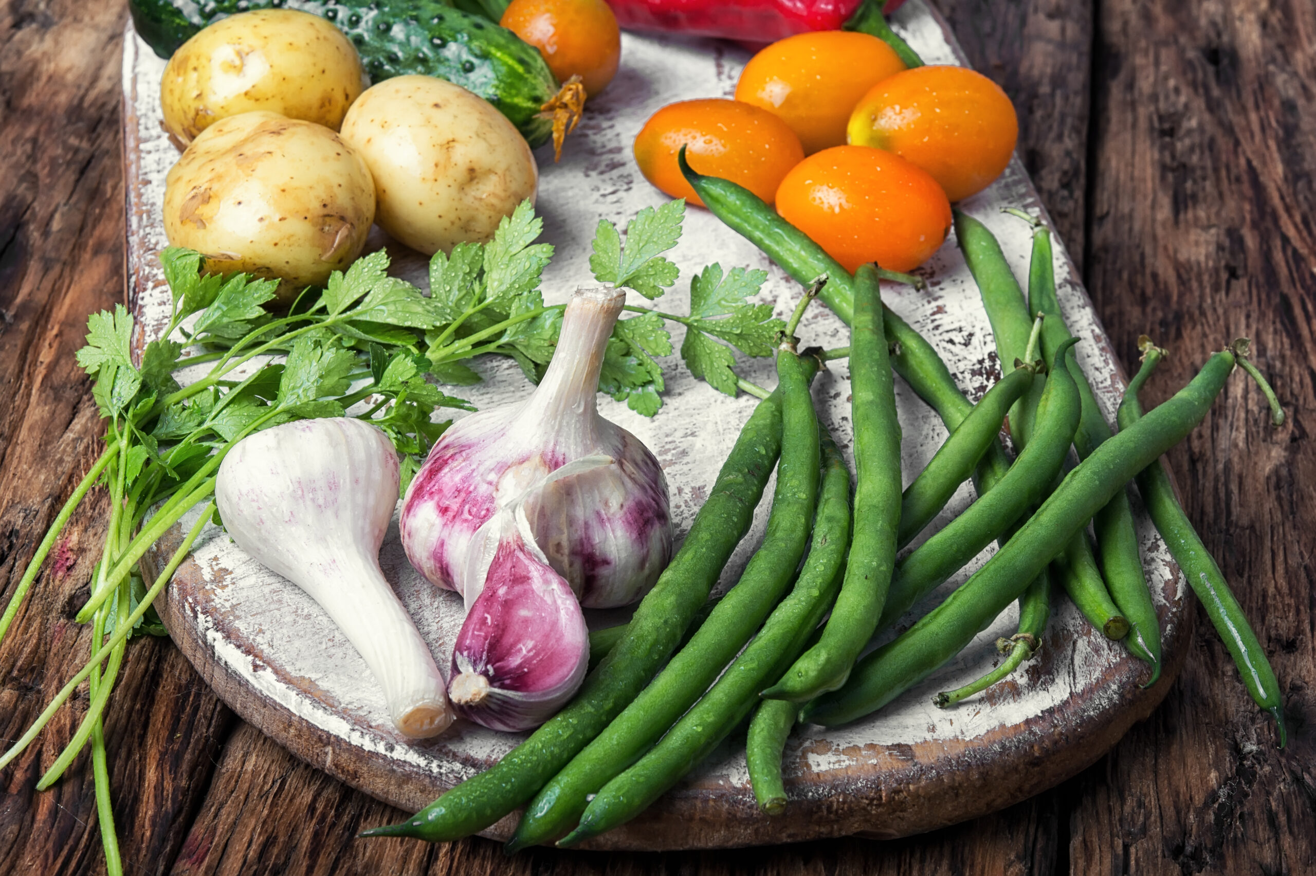 Fresh vegetables. Composition with assortment raw vegetables.Beans in pods, basil, orange tomato, pepper and potatoes